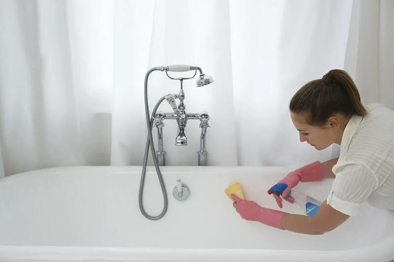 house cleaner doing bathtub cleaning 
