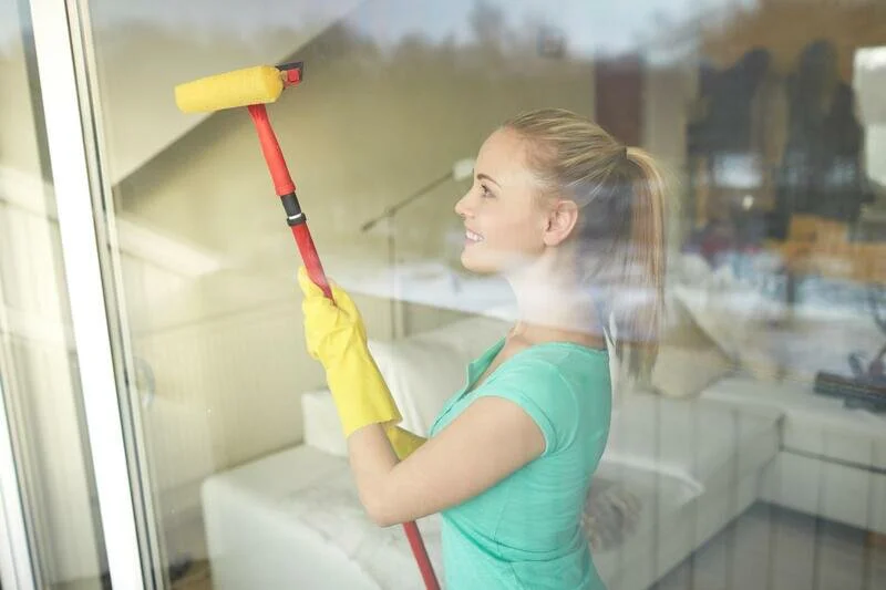 house cleaner cleaning window glasses 